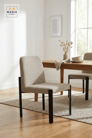 Beige Upholstered Dining Chair with Black Metal Legs for Home Dining Spaces