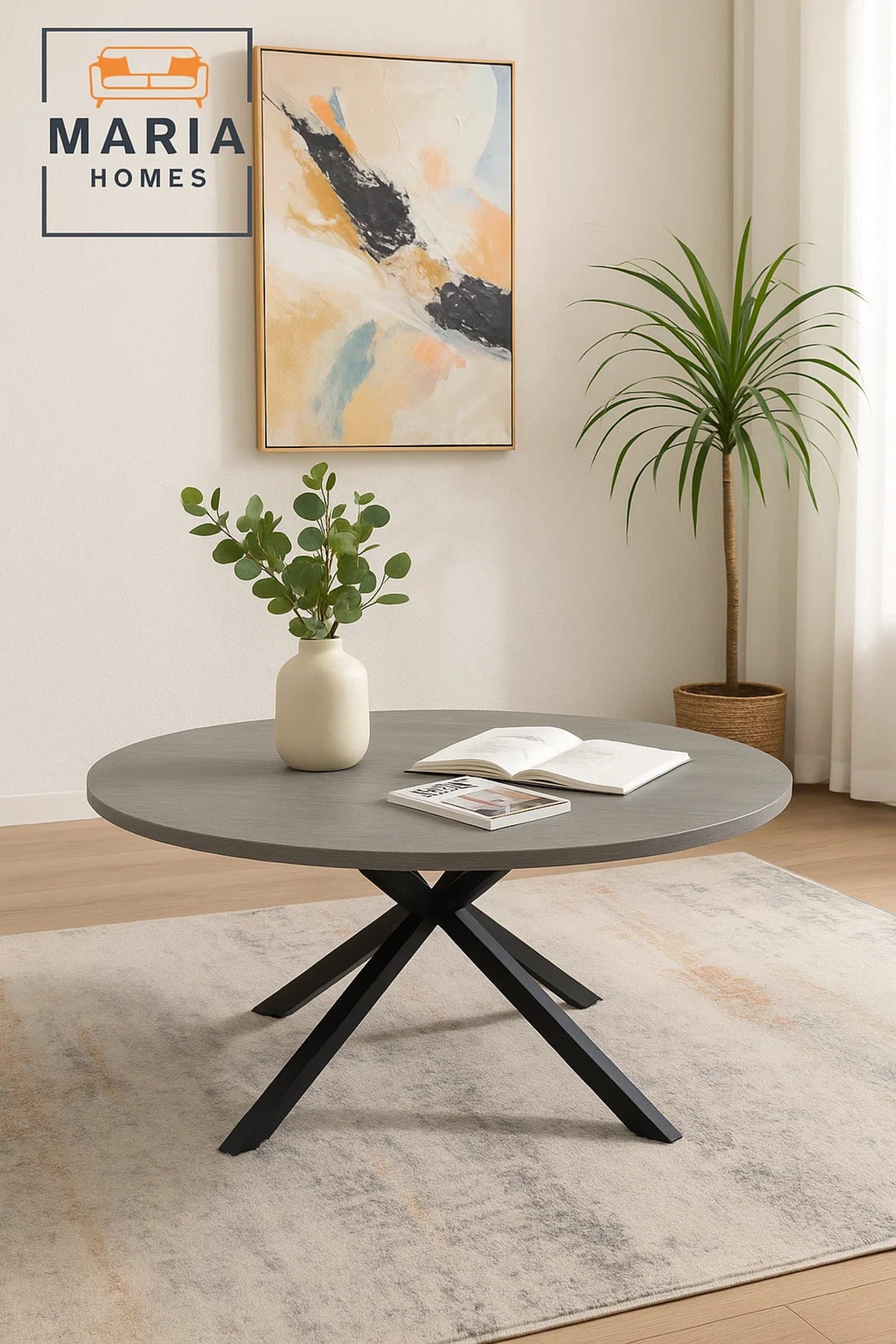 Grey stone round coffee table with angled black metal legs
