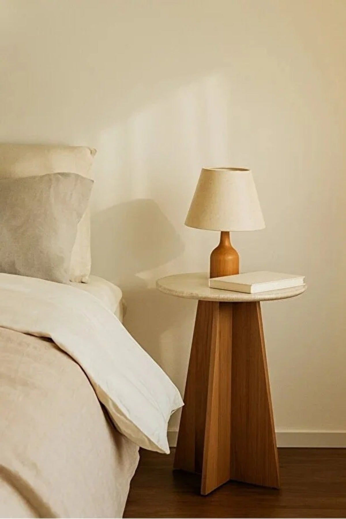 Round side table with a black wooden base Ð a distinctive modern table 45x55 cm