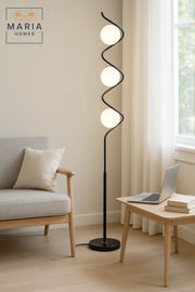 Stylish floor lamp with a spiral black frame and three frosted globes Great for modern interiors